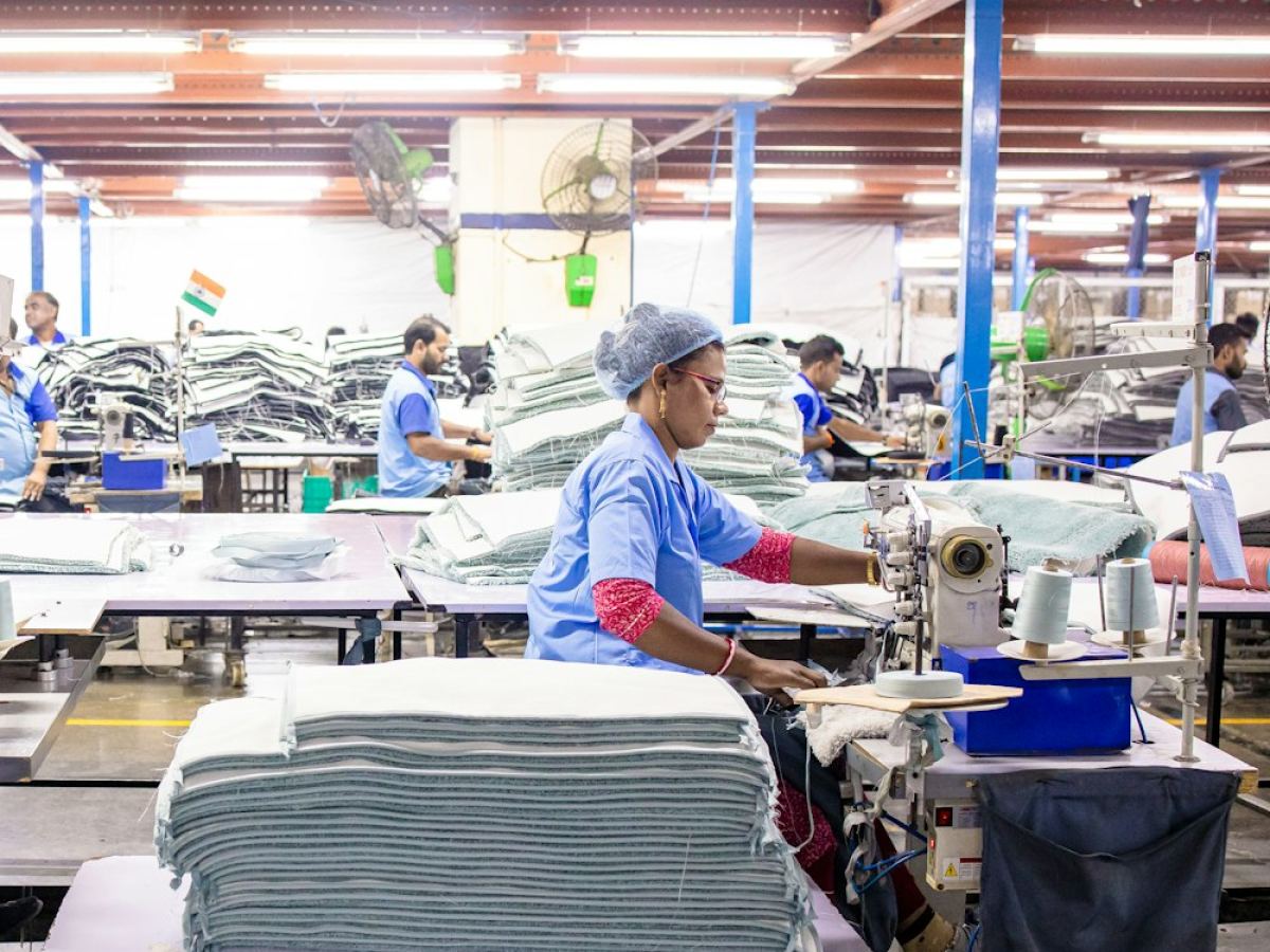 Operators sewing on a production line inside the plant